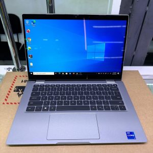 Dell Latitude 5320 13.3-inch business laptop open, showing its black carbon fiber palm rest, backlit keyboard, large touchpad, and display with optional privacy screen.